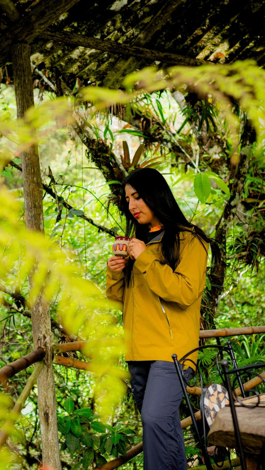 Visitor in a yellow jacket walking through the vegetation